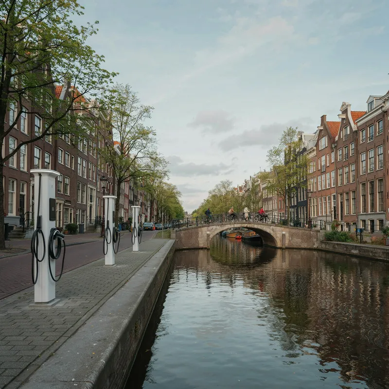 EV charging points beside an Amsterdam canal, bridge and historic streetscape